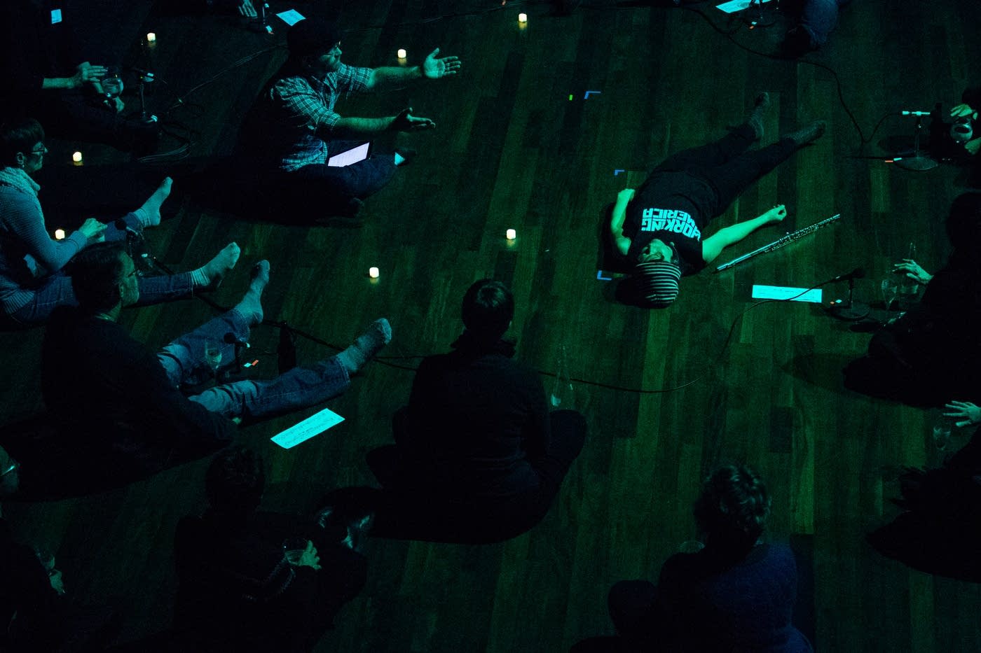 Claire Chase lays on stage during rehearsal, photo by Evan Frost, for Minnesota Public Radio